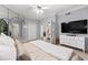 Spacious main bedroom includes a TV, mirrored wall, and en-suite bathroom access at 2161 Peachtree Ne Rd # 508, Atlanta, GA 30309