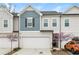 Charming two-story townhome featuring a two-car garage and lovely curb appeal with manicured landscaping at 456 Millsap Way, Marietta, GA 30060