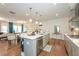 Modern kitchen with a center island, pendant lighting, stainless steel appliances, and hardwood floors at 456 Millsap Way, Marietta, GA 30060