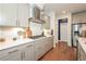 Modern kitchen features stainless steel appliances, quartz countertops and beautiful hardwood flooring at 456 Millsap Way, Marietta, GA 30060