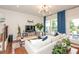 Inviting living room with hardwood floors, large windows, stylish furniture, and a walk out to patio at 456 Millsap Way, Marietta, GA 30060