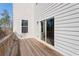 A wooden back deck is shown with sliding glass door access and view of the natural surroundings at 514 Eagles Pt, Fairburn, GA 30213