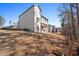 The home has a large backyard showing back of home with wood deck and neutral siding at 514 Eagles Pt, Fairburn, GA 30213