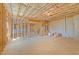 The unfinished basement features exposed ceiling beams, concrete floors, and framed walls at 514 Eagles Pt, Fairburn, GA 30213