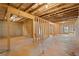 The unfinished basement features wood framing, concrete floor, and natural light from the window at 514 Eagles Pt, Fairburn, GA 30213
