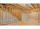The unfinished basement with exposed ceiling and framing, staircase, and concrete floor at 514 Eagles Pt, Fairburn, GA 30213