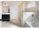 This bathroom features a walk-in shower and tub with marble style tile and dark cabinets at 514 Eagles Pt, Fairburn, GA 30213