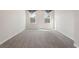 Bright bedroom has two windows and neutral colored walls at 514 Eagles Pt, Fairburn, GA 30213