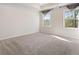 Spacious, carpeted room features two windows and a tray ceiling at 514 Eagles Pt, Fairburn, GA 30213