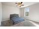 Bedroom with neutral carpet and walls, a ceiling fan, and a bed with a blue patterned comforter at 514 Eagles Pt, Fairburn, GA 30213