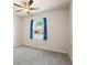 Bedroom with neutral carpet, ceiling fan, and window with patterned curtains at 514 Eagles Pt, Fairburn, GA 30213