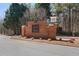 Elegant brick community entrance with sign and manicured landscaping in the South Wind neighborhood at 514 Eagles Pt, Fairburn, GA 30213
