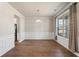 Elegant dining room with wood floors, wainscoting and a large window at 514 Eagles Pt, Fairburn, GA 30213
