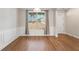 Bright dining room with wood floors and a large window overlooking the yard at 514 Eagles Pt, Fairburn, GA 30213