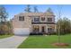 Charming two-story brick home with a well-manicured lawn and inviting front porch at 514 Eagles Pt, Fairburn, GA 30213