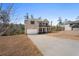 Traditional two-story brick home with a two-car garage and long driveway at 514 Eagles Pt, Fairburn, GA 30213