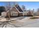 Clubhouse exterior with well-maintained landscaping, architectural detail, and a sunny sky at 514 Eagles Pt, Fairburn, GA 30213