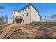 View of home's rear exterior, showing siding, windows, and a wooden deck, set on a sloped lot at 514 Eagles Pt, Fairburn, GA 30213