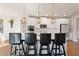 Modern kitchen with white cabinets, stainless steel appliances, and stylish pendant lighting at 514 Eagles Pt, Fairburn, GA 30213