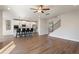 Spacious living room open to kitchen featuring hardwood floors and modern lighting at 514 Eagles Pt, Fairburn, GA 30213