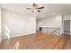 Spacious loft with hardwood floors, ceiling fan, recessed lights, and traditional wood railing at 514 Eagles Pt, Fairburn, GA 30213