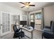 Comfortable office space with french doors, carpet, ceiling fan, and a large window at 514 Eagles Pt, Fairburn, GA 30213