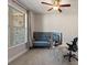 Home office with large window, carpet, ceiling fan, and a gray decorative love seat at 514 Eagles Pt, Fairburn, GA 30213