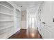 Hallway with hardwood floors, built-in shelving, and elegant wainscoting at 789 Pathview Ct, Dacula, GA 30019