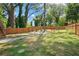 Fenced backyard with a grassy area and a stone fire pit area at 1052 Donnelly Sw Ave, Atlanta, GA 30310