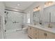 Bathroom features double vanity, quartz countertops, glass shower, and modern fixtures at 1052 Donnelly Sw Ave, Atlanta, GA 30310