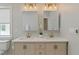 Bathroom featuring double vanity, quartz countertops, modern fixtures, and a decorative plant at 1052 Donnelly Sw Ave, Atlanta, GA 30310