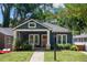 Charming blue bungalow with a tidy front lawn, a classic porch, and decorative string lights at 1052 Donnelly Sw Ave, Atlanta, GA 30310