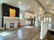 Open-concept living room featuring a fireplace, modern kitchen, and hardwood floors at 1052 Donnelly Sw Ave, Atlanta, GA 30310