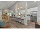 Open concept kitchen and dining area with stainless appliances, bar seating, and modern lighting at 1052 Donnelly Sw Ave, Atlanta, GA 30310