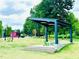 Scenic park view featuring an outdoor pavilion with a concrete base and green Adirondack chairs at 1052 Donnelly Sw Ave, Atlanta, GA 30310