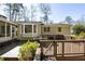 An inviting wooden deck with a seating area perfect for outdoor relaxation and entertaining with lush surroundings at 1716 N Springs Dr, Atlanta, GA 30338