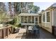 Wooden patio featuring a dining table set with access to the sunroom at 1716 N Springs Dr, Atlanta, GA 30338