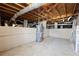 Unfinished basement featuring concrete walls and floor, exposed ceiling, and water heater at 1716 N Springs Dr, Atlanta, GA 30338