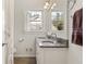 Bathroom featuring a double granite vanity with natural lighting at 1716 N Springs Dr, Atlanta, GA 30338