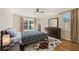 Bright bedroom featuring a large window, ceiling fan, hardwood floors, and patterned rug at 1716 N Springs Dr, Atlanta, GA 30338