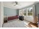 Stylish bedroom with light blue walls, natural light, and hardwood floors at 1716 N Springs Dr, Atlanta, GA 30338