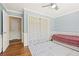 Stylish bedroom featuring light blue walls, natural light, and hardwood floors at 1716 N Springs Dr, Atlanta, GA 30338