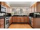 Traditional kitchen with stainless steel appliances, granite countertops, and a window above the sink at 1716 N Springs Dr, Atlanta, GA 30338