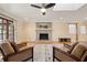 Cozy living room featuring a brick fireplace, hardwood floors, and comfortable seating at 1716 N Springs Dr, Atlanta, GA 30338