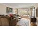 Comfortable living room featuring a large sectional sofa, a bay window, and hardwood floors at 1716 N Springs Dr, Atlanta, GA 30338