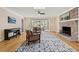 Inviting living room featuring a brick fireplace, hardwood floors, and access to a screened porch at 1716 N Springs Dr, Atlanta, GA 30338