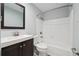 Updated bathroom with white tiled shower and dark vanity at 3252 Westbrook Trce, Lawrenceville, GA 30044