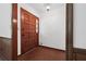 Entryway with a paneled wood door, brown tile floors, and white walls at 3252 Westbrook Trce, Lawrenceville, GA 30044