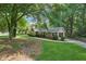 Ranch home with a beautiful lawn, mature trees, and a side entry two-car garage at 3252 Westbrook Trce, Lawrenceville, GA 30044