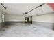 Attached garage with neutral walls and concrete floor at 3252 Westbrook Trce, Lawrenceville, GA 30044